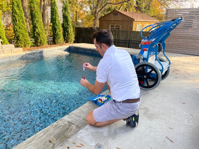 Joel of Pool Defenders checking the pH level of a Nashville home pool.